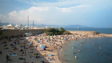 Antibes, Fransa - 20 Temmuz 2024: İnsanlar denizde yüzüyor ve plajda dinleniyorlar