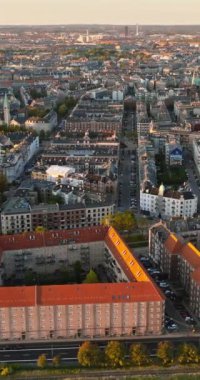 Danimarka, Kopenhag 'daki Vesterbro bölgesinin hava aracı görüntüsü gün batımında. Dikey