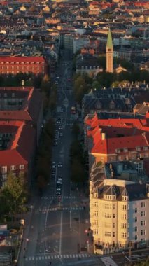 Danimarka, Kopenhag 'daki Vesterbro bölgesinin hava aracı görüntüsü gün batımında. Dikey