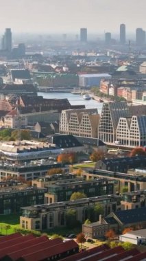 Kopenhag, Danimarka 'da gündüz vakti suyla çevrili Paper Island kentsel vahasının insansız hava aracı görüntüsü. Dikey