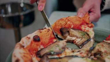 Patlıcanla pizza doğrayan ve restoranda yiyen bir kadının fotoğrafını çek.