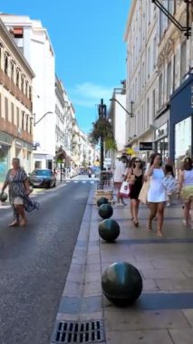 Cannes, France - October 15, 2024: People walking on the streets of the city in daylight. Vertical