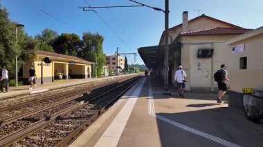 Beaulieu-sur-Mer, Fransa - 5 Temmuz 2024: İnsanlar gün ışığında Gare de Beaulieu-sur-Mer 'de tren bekliyor