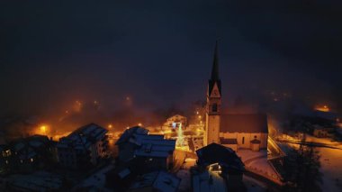 San Lorenzo Kilisesi 'nin insansız hava aracı görüntüsü Dolomites, İtalya' daki Selva di Cadore komün 'ünde gece aydınlandı.