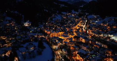 Ortisei kasabasının hava aracı görüntüsü gece karla kaplı, Dolomitler içinde, kuzey İtalya 'da.