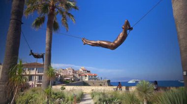 Antibes, Fransa - 13 Ağustos 2024: Arka planda Nicolas Lavarenne 'in bronz heykelleri görülüyor