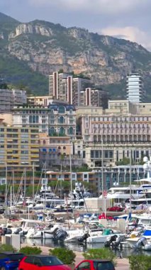 La Condamine, Monaco - 25 Ağustos 2024: Monaco Marina 'da arka planda şehrin ufuk çizgisi olan teknelerin görüntüsü. Dikey