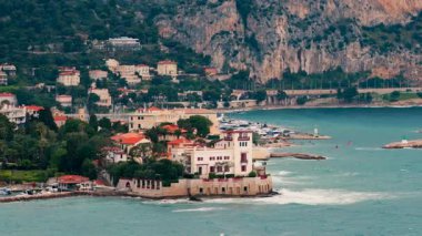 Beaulieu-sur-Mer, France Distant view of the Villa Kerylos with the mountains on the background