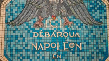 Golfe-Juan, France Close up of a blue mosaic plaque with a historical inscription in French on the Napoleon Monument