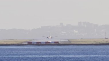 Distant view of airplanes landing at the Nice Cote d'Azur Airport in daylight