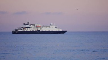 Nice, France Distant view of a cruise ship moving on the sea in the evening