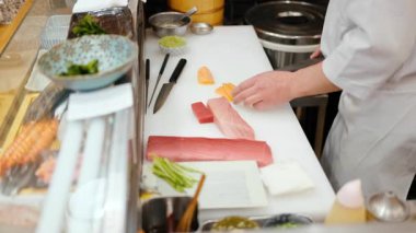 Close up of a chef cutting fish at the Tsukiji Fish Market in Japan