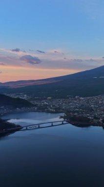 Aerial drone view of the Kawaguchiko-Ohashi bridge near the Fujikawaguchiko town in Japan with Mount Fuji on the background