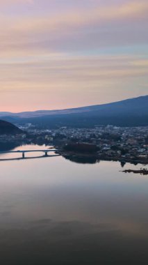 Aerial drone view of the Kawaguchiko-Ohashi bridge near the Fujikawaguchiko town in Japan with Mount Fuji on the background