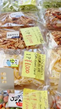 Japonya 'daki Tsukiji Balık Pazarı' nda satılık plastik poşetlerde farklı kurutulmuş deniz ürünleri. Dikey