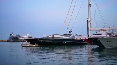 Cannes, Fransa - 23 Ağustos 2024: Fransa 'nın Port de Cannes limanına akşam saatlerinde yanaşan teknelere binen bir adam