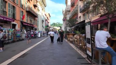 Güzel, Fransa - 20 Temmuz 2025: Güneşli bir günde insanlar şehrin sokaklarında yürüyor