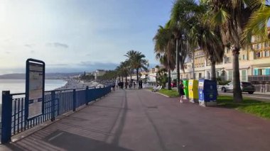 Nice, Fransa - 20 Temmuz 2025: Güneşli bir günde kıyı şeridi yakınında gezinen insanlar