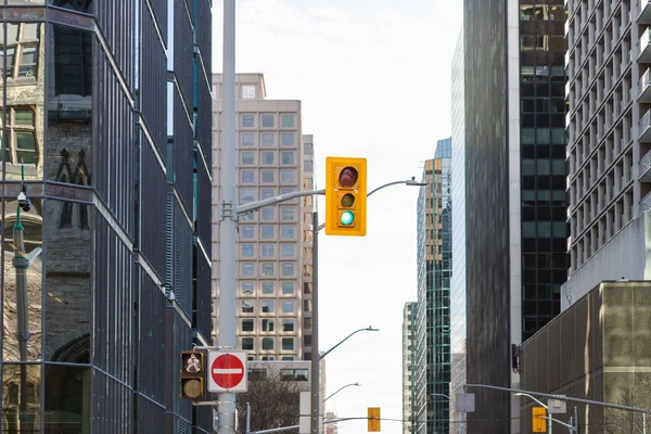 stock image Traffic light against sky and tall office buildings in downtown Ottawa, Canada. Skyscrapers in business district of the city.