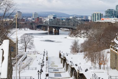 Ottawa, Canada - January 23, 2023: Rideau canal, Ottawa river, Alexandra bridge and Gatineau city of Quebec in winter season. Popular canadian travel destination