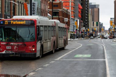 Ottawa, Canada - January 23, 2023: Public bus in downtown of Ottawa, Rideau street with bike lane