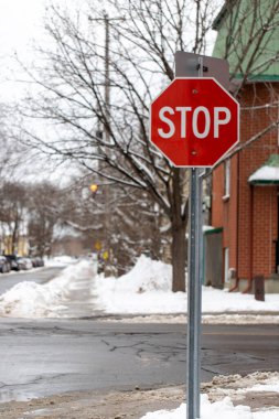 Stop sign in a residential neighborhood at crossroads in winter