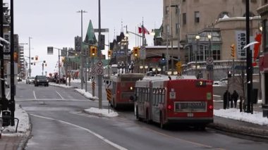 Ottawa, Canada - January 23, 2023: Bus on Rideau Street in downtown with Parliament building.