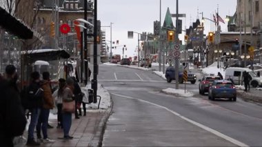 Ottawa, Canada - January 23, 2023: Bus stop on Rideau Street in downtown. People are waiting at the bus stop for a trip by public transport