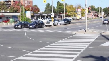 Ottawa, Kanada - 6 Ekim 2021: Ottawa 'daki Baseline ve Greenbank yollarının kesişiminde güneşli bir günde trafik ışıkları, yaya geçidi ve caddelerde arabalar