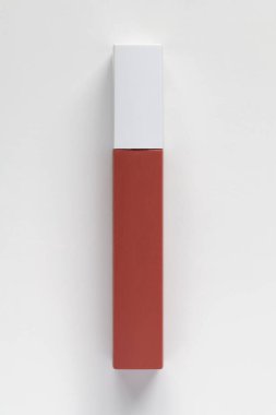 Liquid coral lipstick on a white background