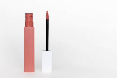 Open liquid lipstick standing on white background with copy space