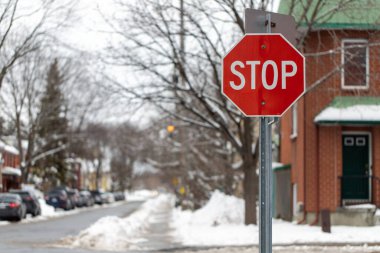 Stop sign in a residential neighborhood at crossroads in winter