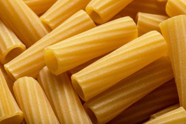 Uncooked dry pasta. Food background. Close up of noodles.