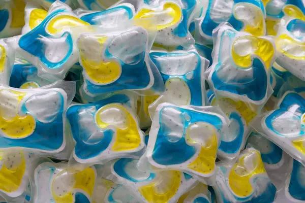 Dishwasher detergent and or laundry soap capsules, close up background