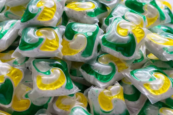 Dishwasher detergent capsules and or laundry soap close up background