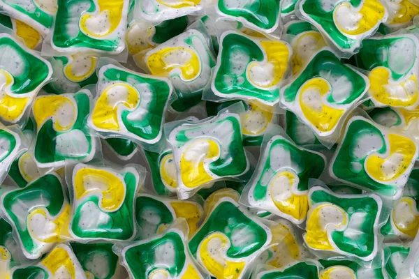 Dishwasher detergent capsules pile and or laundry soap background