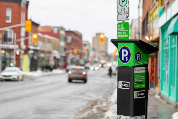 Ottawa, Canada - January 23, 2023: Parking meter on city road. Pay by phone available