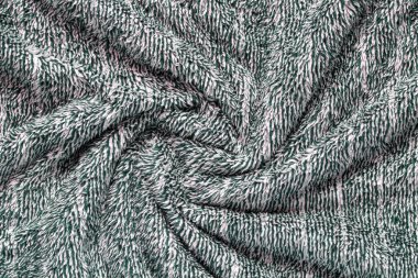 Koyu yeşil yumuşak yumuşacık kumaş. Döndürülmüş sıcak battaniye arka planı.