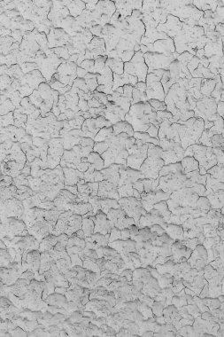 Peeling grey paint on the wall. Old cracked textured background. clipart