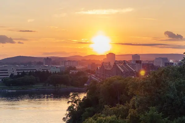 stock image Ottawa, Canada - June 4, 2024: Ottawa River and Gatineau city of Quebec in Canada during sunset. Alexandra bridge