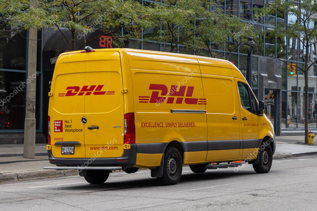 Ottawa, Canada - October 1, 2024: Yellow DHL delivery van on the road.