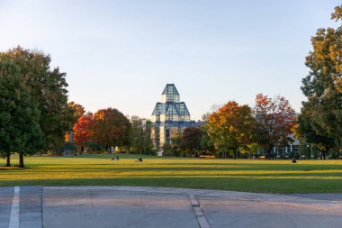Ottawa, Kanada - 17 Ekim 2024: Major 's Hill Park, şehir merkezinde insanlar sonbahar sezonunda çimlerin üzerinde oturuyorlar. Kanada Ulusal Galerisi