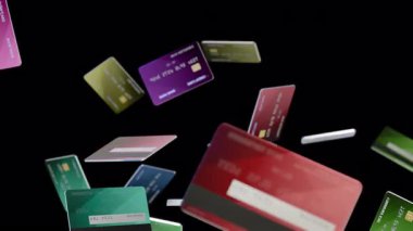Finansı sembolize eden, siyah bir fona karşı serbest düşüşte çeşitli kredi kartları ve tasarımlar tasvir edilir,