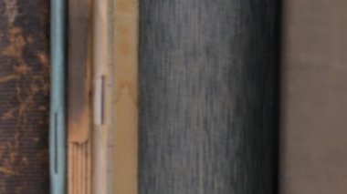 Old books in a book shop or library, university library rows, close-up macro. Defocused footage.