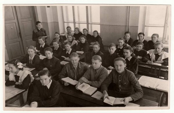 USSR - CIRCA 1950S: Vintage photo shows schoolmates at school desks.