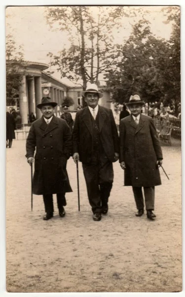 ラーズニェ ポジェブラディ 1930 年代のチェコスロバキア共和国 ヴィンテージ写真はスパ リゾートのエレガントな男性を示しています 彼らは帽子を着用し 杖を保持します 背景には 列柱です — ストック写真
