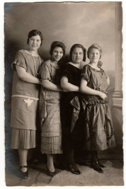 HAMBURG, GERMANY - CIRCA 1930 'lar: Klasik fotoğraf bir grup kızın fotoğraf stüdyosunda poz verdiğini gösteriyor. Sepya etkisi olan siyah ve beyaz geçmişe dönük fotoğrafçılık. Çember 1930 'lar.