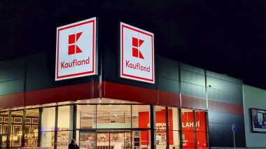 HUSTOPECE, CZECH REPUBLIC - DECEMBER 14, 2023: Kaufland logo on hypermarket from German chain, part of Schwartz Gruppe which also owns Lidl. It operates over 1,500 stores in Germany, Croatia, the Czech Republic, Slovakia, Poland, Romania, Bulgaria an clipart