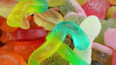 Arka planda jelatin tatlılar. Lezzetli jöle şeklinde. Meyve aromalı jöle tatlısı kavramı. Üst manzara, makro çekim. Şeker ve şekerleme kavramı