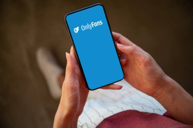 Riga, Latvia - February 24, 2023: OnlyFans logo on mobile phone. OnlyFans is an internet paid content subscription service.
